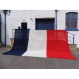 An extremely large French flag, 221 1/4 x 153" plus a St. George's flag, 35 x 70".