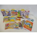 A collection of unusued MacDonalds packaging including boxes and bags.