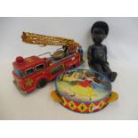 A Japanese tinplate Fire Dept. engine, a Chad Valley tambourine and a plastic black doll with