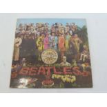 Beatles Sargent Pepper, first pressing mono, vinyl appears VG+ buffering to cover.