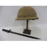 A pith hat and a bayonet.