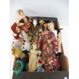 A box of unusual dolls, including wooden and porcelain, some from countries around the world.