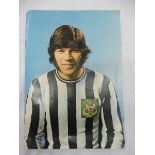 An autographed photograph of Malcolm MacDonald signed to verso.