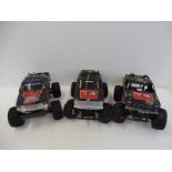 Three Bigfoot style remote controlled vehicles including Tamiya.
