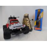 A boxed Pelham Puppet Thunderbird figure, a Chinese plastic dalek and a remote controlled car.