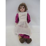 An Armand Marseille bisque headed doll with open mouth, stamped to reverse of head: AM 4/0 DEP