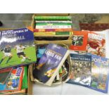 Three boxes of football related books.