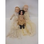A small German bisque headed doll stamped to reverse 15/0 plus two large bisque headed dolls, each