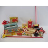 A selection of tinplate and other toys including a 'Miss Housewife Carpet Sweeper' and a boxed