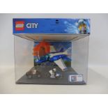 An extremely rare illuminated shop display case containing the Lego City Sky Police Parachute Arrest