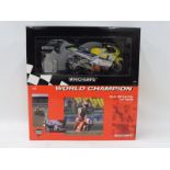 Two boxed Minichamps scale models of racing mototrcycles.