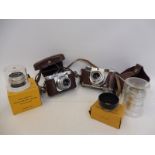 A Voightlander Vito B camera plus a Kodak camera and various lenses etc.