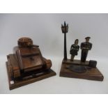 A well made wooden scale model of a war time tank, made as a cigarette dispenser and a figure of