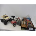 A collection of remote controlled vehicles including a big foot style plus a Nitro Sport etc.