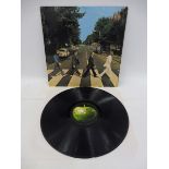 A Beatles Abbey Road album, a first press on the Apple label, with misaligned apple to rear of