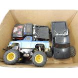 Three Tamiya 'Big Foot' remote controlled vehicles.