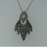 An unusual pave set diamond Pendant, probably Indian, formed of two hinged parts, the top with a