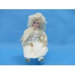 An antique bisque head doll, early 20thC, marked to neck '476 8 W', with sleeping blue glass eyes,