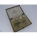 A cased set of evening Studs and Buttons, comprising two small studs, three buttons, the forth