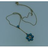 A turquoise flowerhead Pendant, with central seed pearl, all mounted in 9ct yellow gold and