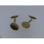 A pair of 9ct yellow gold Cufflinks, the front of oval form with detailed border, with chain and