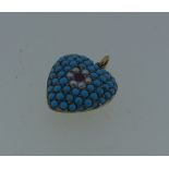 A pretty heart shaped Pendant, pave set with turquoise, the centre set with seed pearl and pale ruby