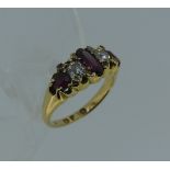 A five stone ruby and diamond Ring, the central narrow oblong ruby with two circular diamonds on