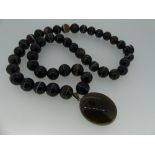 A finely graduated banded agate Necklace and Pendant, formed of 44 circular sardonyx beads, on a