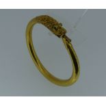 An fine Indian 18ct yellow gold flexible Serpent Bracelet, the head well tooled and with emerald