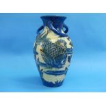 A large Brannam Barum Ware pottery vase, of baluster form with three scroll handles, decorated