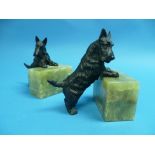 A pair of early 20th century painted bronze and green marble Scottie Dog book ends, each dog perched