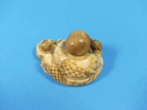 A 19th century Japanese carved ivory Netsuke, depicting a man and boy with a small bird, signed on - Image 3 of 4