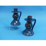 A pair of Royal Torquay Pottery chamber sticks, mottled blue ground with floral decoration, 5¾in (