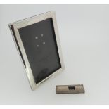 A small sterling silver Easel Frame, of plain rectangular form marked '950 sterling', wooden easel