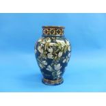 A Doulton Lambeth Faience vase, of baluster form painted with flowers and leaves on a dark green