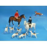 A Beswick pottery nine-piece Hunting group, comprising Huntsman, MN.1501, brown horse; Huntswoman,