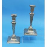 A pair of George V silver Candlesticks, by Reid & Sons, hallmarked London. 1913, square bases with