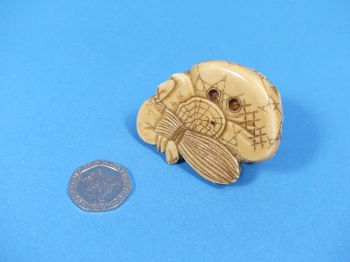 A 19th century Japanese carved ivory Netsuke, depicting a man and boy with a small bird, signed on - Image 2 of 4