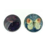 A Moorcroft ceramic Brooch, pansy pattern, marked on reverse 'Moorcroft' in unmarked silver metal