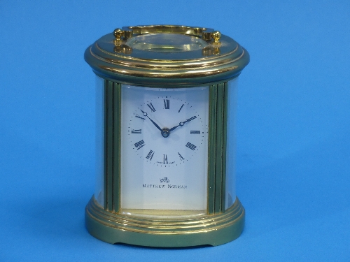 A 20thC gilt-brass oval Carriage Clock, of five-glass form, the white enamel dial with black Roman