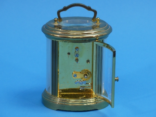 A 20thC gilt-brass oval Carriage Clock, of five-glass form, the white enamel dial with black Roman - Image 2 of 3