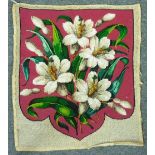 A late Victorian embroidered and beadwork panel, shield-shaped, decorated with lilies on a red