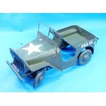 A vintage Tri-ang pressed steel Jeep pedal car, circa 1950's, green with US army markings, some