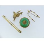 A collection of four gold mounted Brooches, including a Chinese circular jade disc, with gold centre