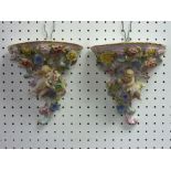 A pair of Dresden porcelain Wall Brackets, of scrolling cornucopia form with applied cherubs and