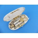 A 19thC French ivory cased Etui, the hinged oval case opening to reveal fitted interior with five