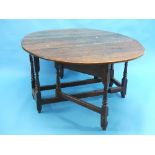 A late 18th century oak gateleg Dining Table, the oval top above shaped aprons, on turned and