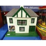 A Triang Dolls House complete with furniture, wooden house with front opening and lift off roof