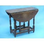 A late 18th century oak gateleg Table, of small size, the oval top above a frieze drawer, on