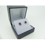 A pair of single stone sapphire Earrings, the radiant cut stones each c.1ct, mounted in a four